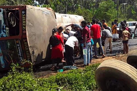 Tanker toppled on road, people near it