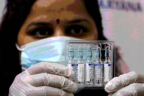 A health workers hold up vials of COVID-19 vaccines