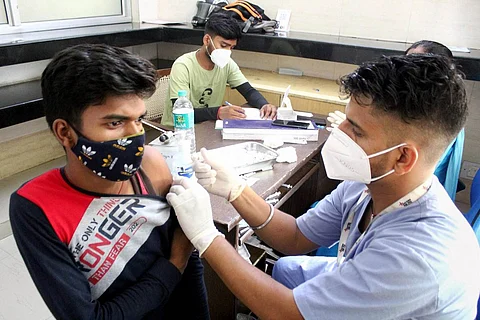 Representative image of a man taking COVID-19 vaccine