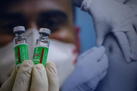 Health worker holding Covid vaccine