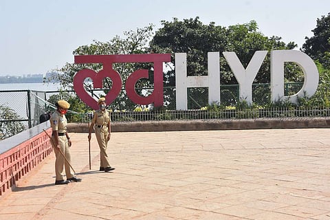 Two police constables standing with lathis at People's Plaza