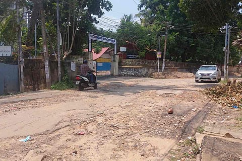 dilapidated stretch of road in front of Vanchiyoor Government High School