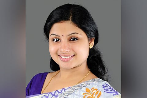 Veena S Nair ,congress candidate from Vattiyoorkavu for Kerala Assembly Elections, wearing saree smiling for the camera
