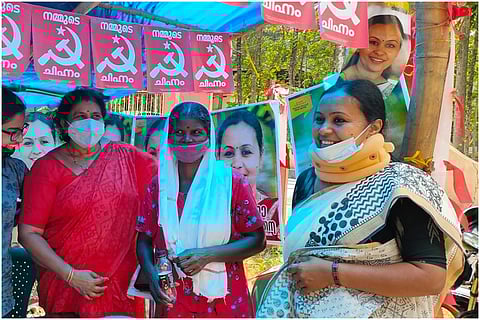 Kerala CPI (M) Candidate Veena George, wearing neck collar and mask, seeking votes