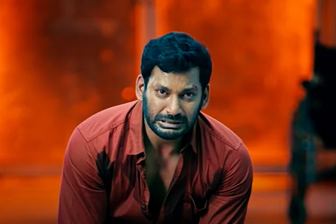 Vishal in a red shirt in Veerame Vaagai Soodum