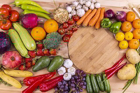 Raw vegetables on display alongside a cutting board
