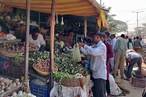 Man buying vegetables at a shop inside a market