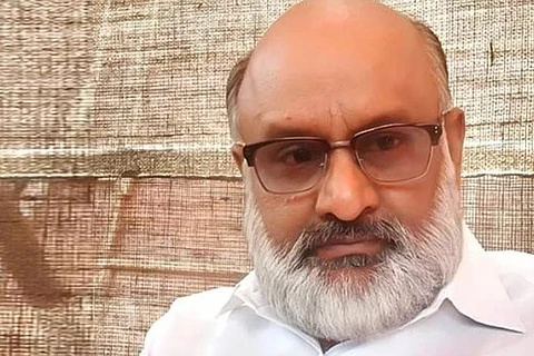 Venkat Subha is seen wearing a white shirt and glasses in the image.