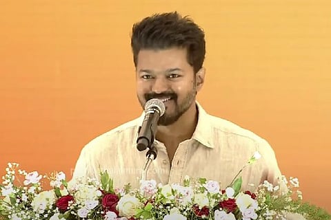Actor Vijay speaking into a mic