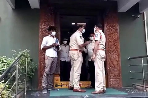Police outside the choultry where the family was staying, Telangana family dies by suicide in Vijayawada, search on for accused moneylenders