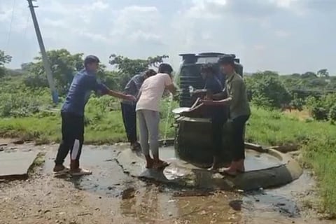 Students at Telangana tribal welfare school in Kulkacharla using water from a storage tank