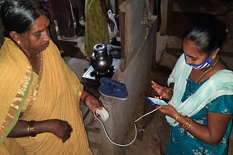 Andhra Pradesh village volunteer providing pension at doorstep