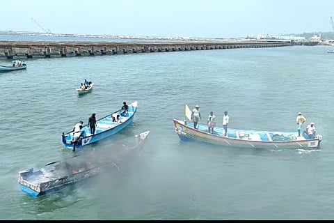 Boat that was set on fire by protesting fisherfolk at Vizhinjam