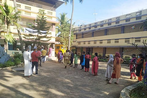 Voters at a local body polling station