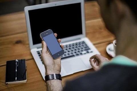 A man in front of a laptop