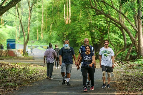 People walk inside Sanjay Gandhi National Park after its gates opened for morning walkers after COVID restrictions were eased in Mumbai