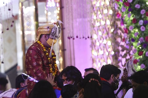 A groom rides on a horse during his wedding procession amid the coronavirus pandemic