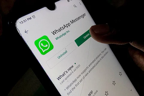 WhatsApp Messenger app on a smartphone device as a thumb clicks on the update button