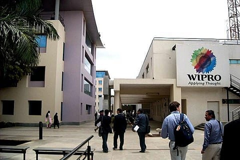 Employees walking into a Wipro campus in India