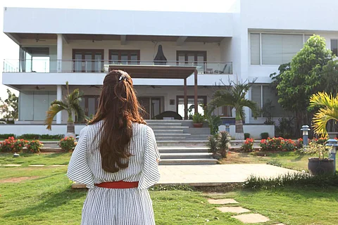 A woman in front of a house