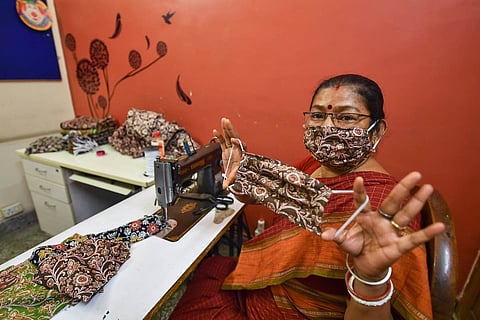 Woman holding up a cloth mask
