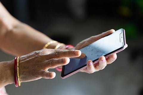 Representative image of a woman holding a phone