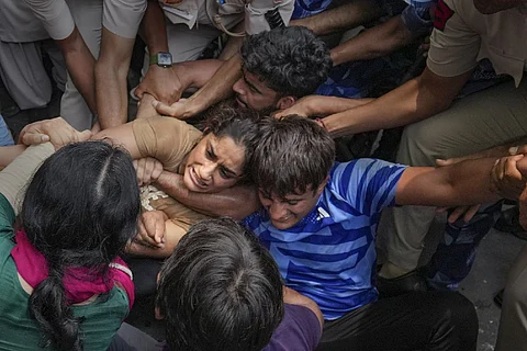 Protesters being manhandled