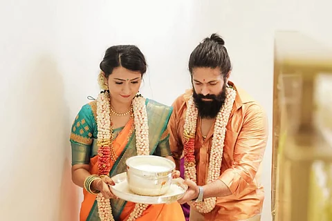 Actors Yash and Radhika Pandit in traditional attire at their housewarming ceremony