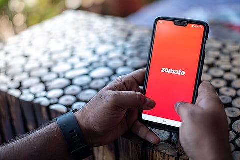 Representative image of a person using Zomato on their phone: Zomato’s Q3FY22 losses narrow to Rs 63 cr, co to invest $400 mn into quick commerce