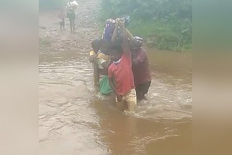 Pregnant woman being carried by relatives in Vishakhapatnam