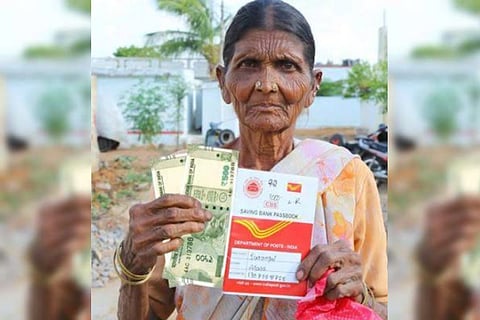 File photo of an elderly woman showing the pension money collected from the Post Office