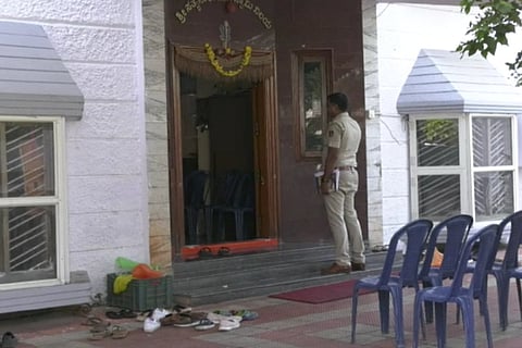 Police in front of Olekar's house