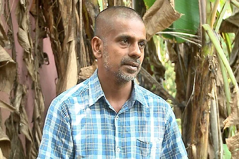 Aji Bright, Kerala man who alleges intimidation five years after custodial torture, outside his house