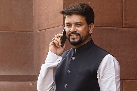 Anurag Thakur speaking on a mobile phone outside Parliament
