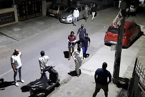 Goons outside victim's house