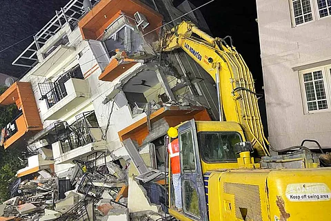 Earthmover being used for razing a building