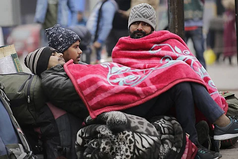 Passengers waiting for a train in the cold