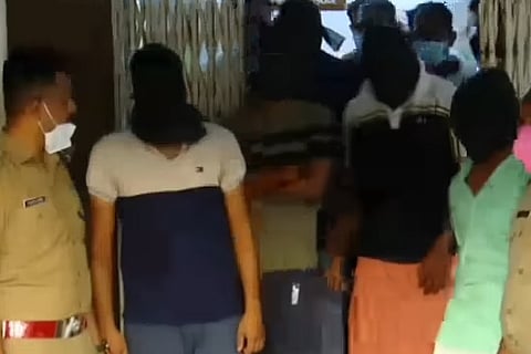 Kerala police with men arrested in the couple-swapping case