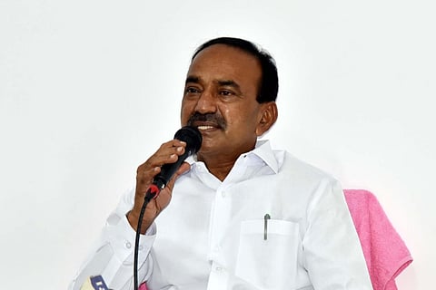 Eatala Rajender in a white shirt addressing the media