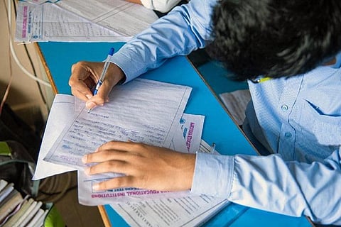 Student writing exam in a school