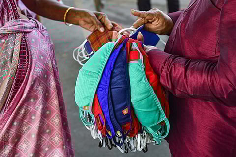 A vendor selling facemasks of many colors