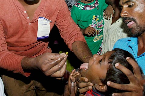 A boy being made to swallow fish prasadam: No annual fish ‘prasadam’ in Hyderabad for third consecutive year
