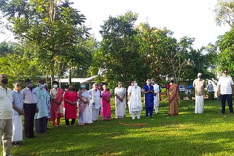 Residents of Graceland gated community in Mulanthurathy in Ernakulam stand in line posing for the camera