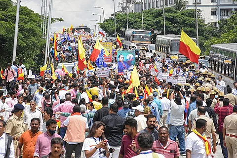 People take part in a protest rally demanding the withdrawal of revised textbooks in Bengaluru