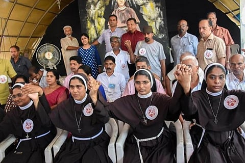 Nuns hold hands in solidarity with sexual assault survivor in Bishop Franco case