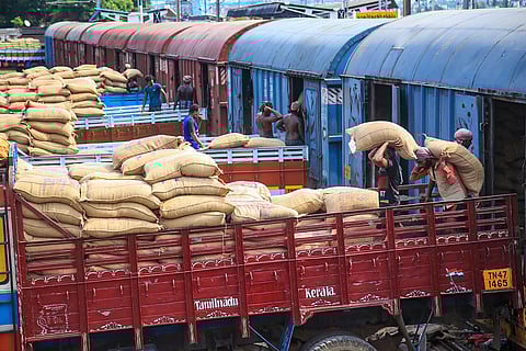 Labourers unloading stock from goods train