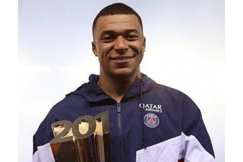 Kylian Mbappe with a trophy after becoming Paris Saint-Germain’s all-time top scorer