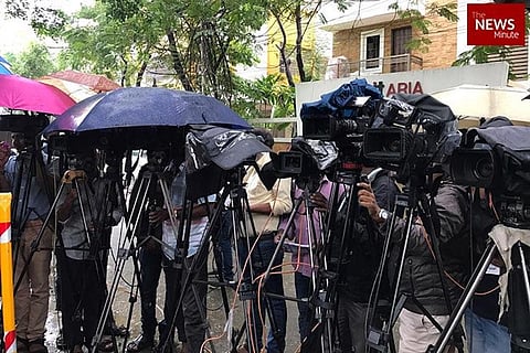 Media personnel holding cameras