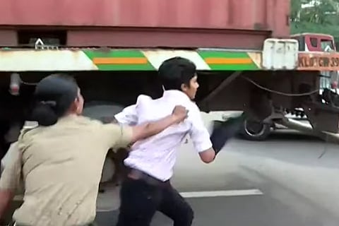 Miva Jolly being dragged by police