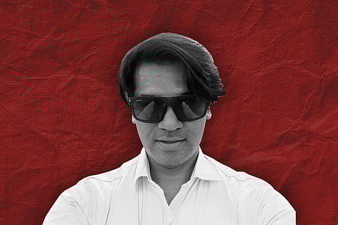 Mohammed Zubair, Alt News co-founder, against a maroon background